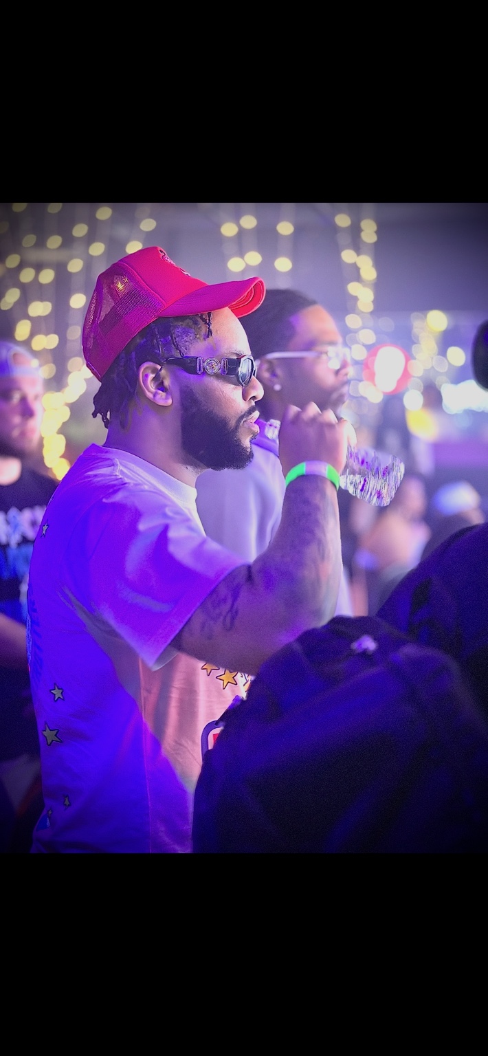 Velly Beretta at a live event under purple lights